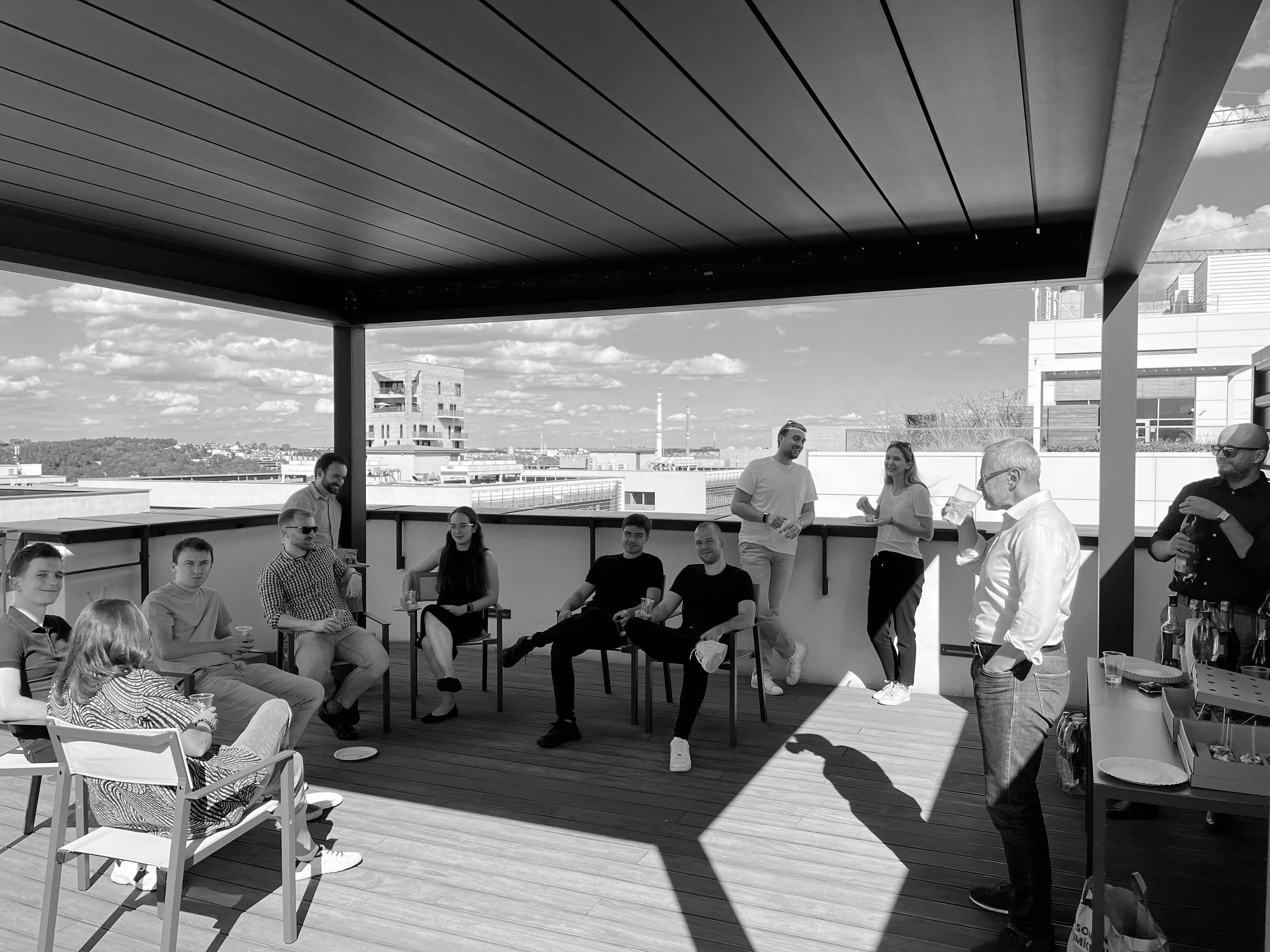 Colleagues gathered on an office terrace.