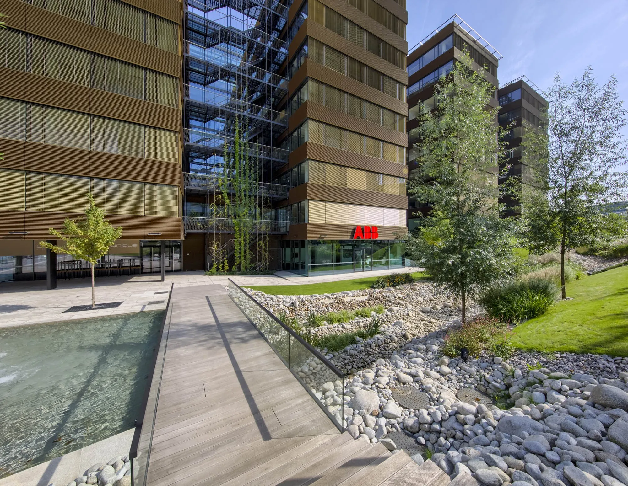 Office buildings beside landscaped gardens and a reflecting pool